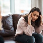 Shot of a young woman having a therapeutic session with a psychologist